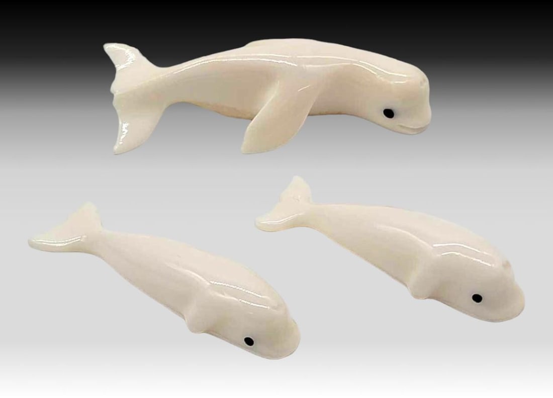 Walrus Tusk & Baleen Beluga Whales - Gordon Oosevaseuk: Three walrus tusk carved beluga whales with inset baleen eyes. Initialed on the underside by "G.O." for Yup'ik artist Gordon Oosevaseuk of Gambell, St. Lawrence Island, Alaska. The largest