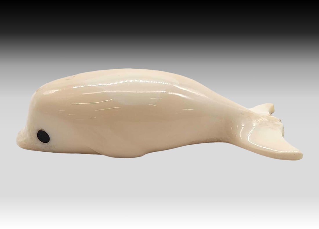Walrus Tusk & Baleen Beluga Whale - Gordon Oosevaseuk: A walrus tusk carved beluga whale with inset baleen eyes. Signed on the underside by Yup'ik artist Gordon Oosevaseuk of Gambell, St. Lawrence Island, Alaska. Measures approximately 3.5" x 1.5&