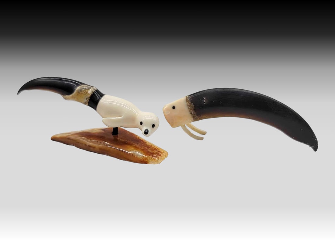 Walrus Tusk & Baleen Accented Polar Bear Claws - Seal & Walrus - Ladd Soonagrook: Two polar bear claws includes one fashioned with a baleen cap terminating in a walrus tusk seal with inset baleen eyes; the seal is mounted upon a richly mineralized section of walrus tusk and signed 