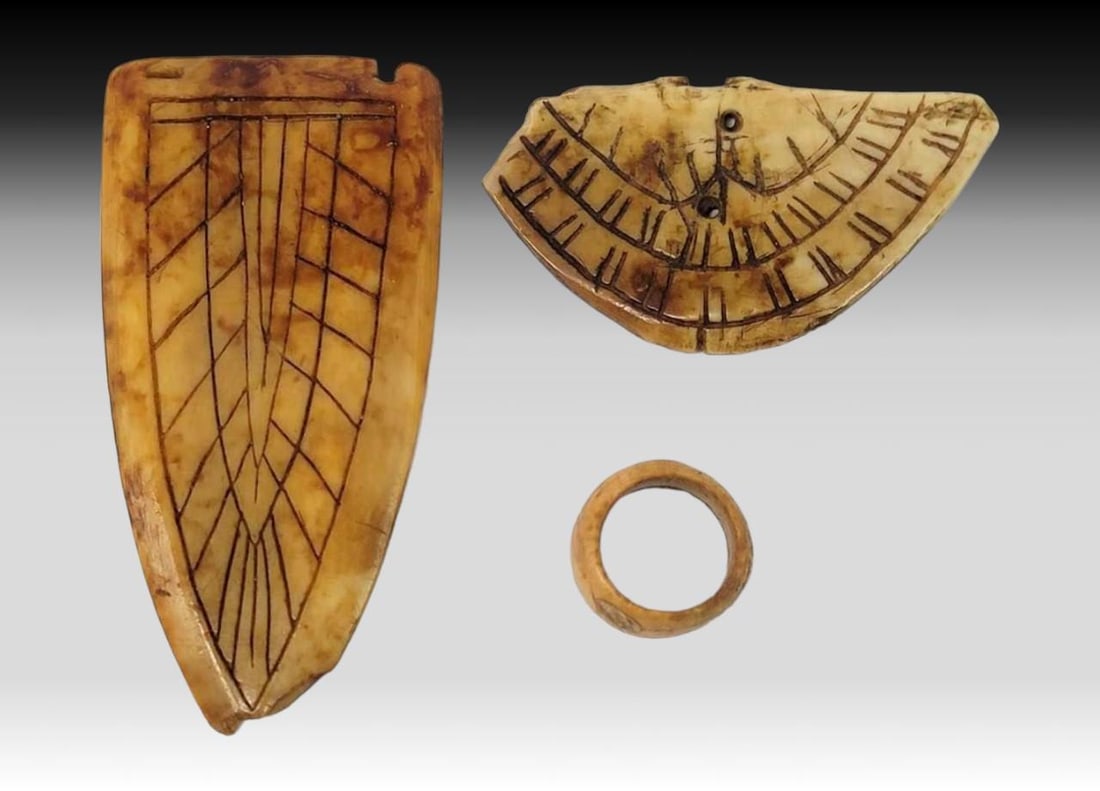 Punuk Jewelry Artifacts: A group of three Punuk period Eskimo jewelry artifacts consisting of two gorgets or amulets decorated with simplistic linework engravings and a highly unusual early ring with geometric relief carvings