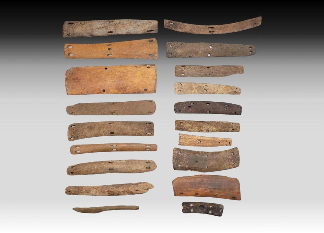 19x Eskimo Body Armor Panels & Box Straps: A grouping of nineteen sections of bone and walrus tusk armor plates and box straps, Thule to 19th century. The largest piece measures approximately 7.25" x 2.5". Note: Please note this item f