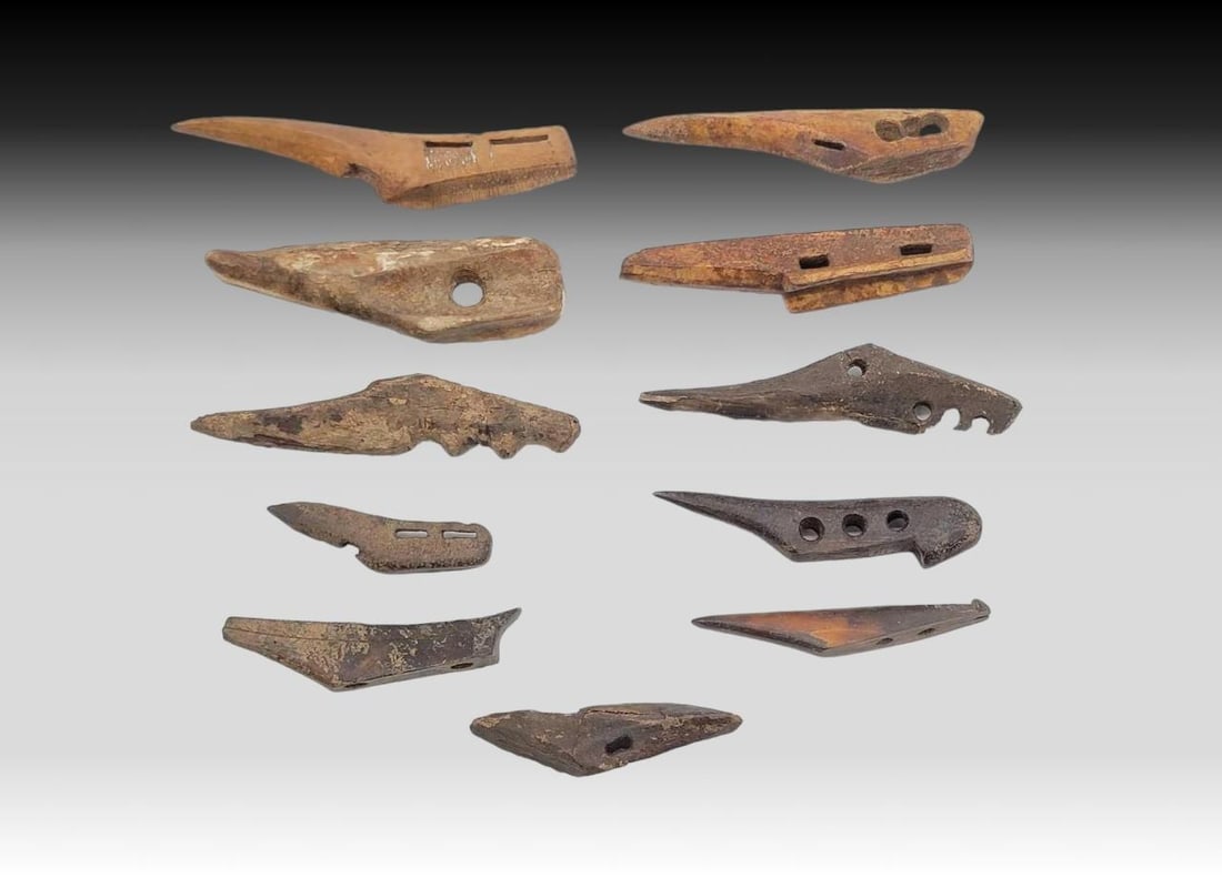 Thule Boat & Meat Hooks: Eleven Thule fossilized walrus tusk hooks, mostly boat riggings/cleats, plus a few meat hooks, in assorted styles and sizes as photographed. The largest measures approximately 1.5" x 4.5" long