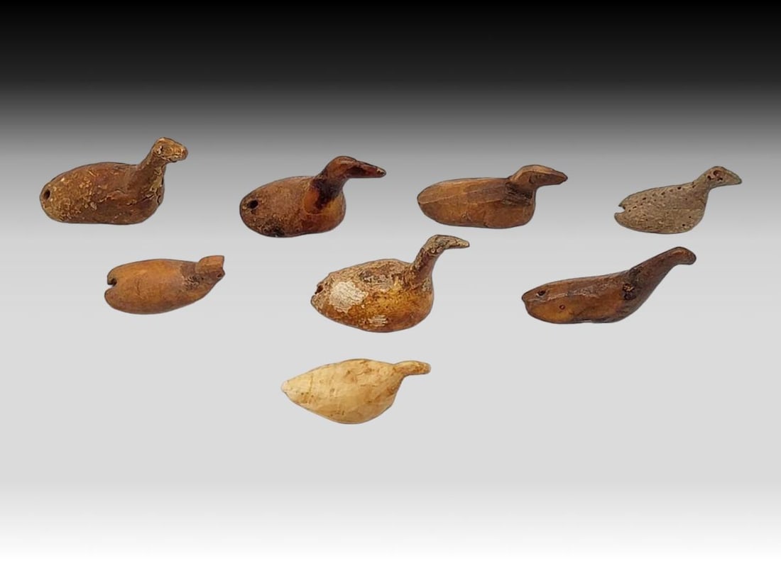 Thule Tingmiujang Gaming Birds: Eight Thule to 19th century fossilized walrus tusk swimming birds, used within the game "tingmiujang" during which the birds were shaken in the hands of the first player, and thrown upward. Up