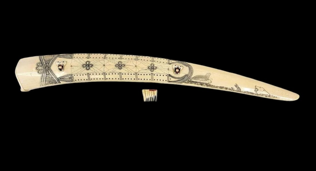 Large King Island Scrimshaw Walrus Tusk Cribbage Board w/ Playing Pegs: A highly detailed mid-20th-century King Island Iñupiaq cribbage board crafted from a walrus tusk and featuring a pair of carved tusk polychrome polar bear faces, each accented with inset baleen eyes 