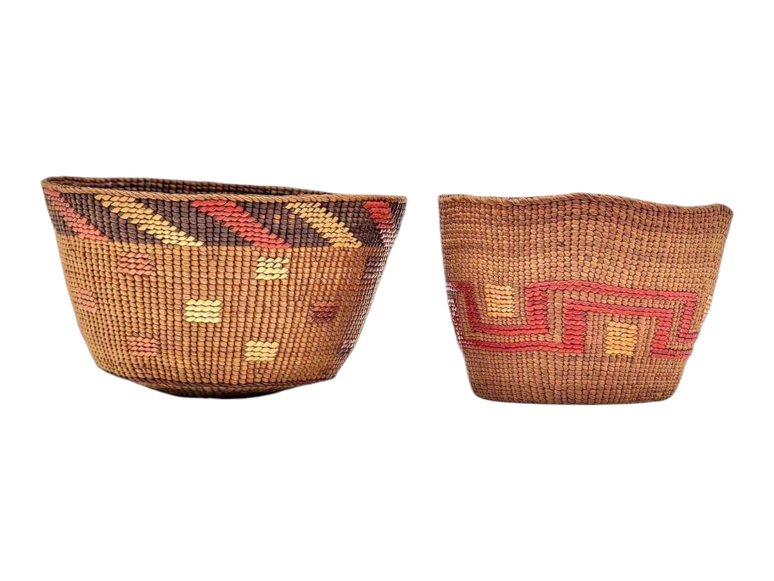 Tlingit Twined Spruce Root Berry Baskets: Two lovely Tlingit twined spruce root berry baskets, the larger with a dyed dark brown band at the rim upon which bright red and yellow false embroidery adds additional contrast. The slightly smaller 