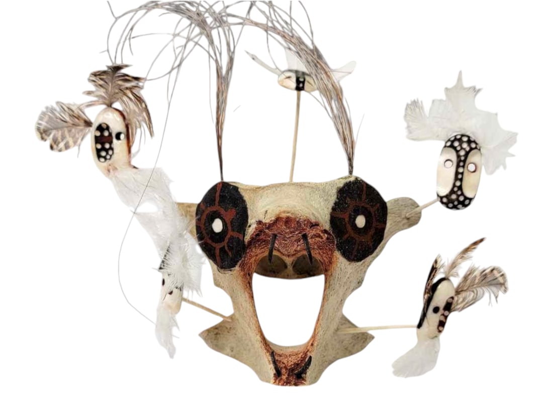 Iñupiaq Vertebrae & Walrus Tusk Spirit Mask - Bellarmine Seeganna: A handcrafted spirit mask featuring a walrus vertebrae face accented with painted eyes, four baleen fangs, and five walrus tusk mask appendages. The appendages are carved, painted, drilled, and embell