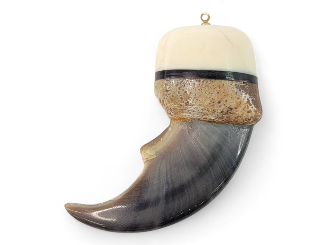 Polar Bear Claw Pendant: A polar bear claw capped with a slice of baleen, and further capped with a section of walrus tusk. A gold-tone bail has been inserted in the end for use as a pendant or earring. Measures approximately