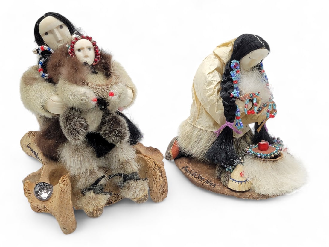 Yup'ik Eskimo Story Dolls - Beulah Oittillian: A pair of handmade story dolls by Yup'ik doll maker Beulah Oittillian, each dressed in fur outfits with colorful bead accents and carved walrus tusk faces and hands. One doll is serving tea and wearin