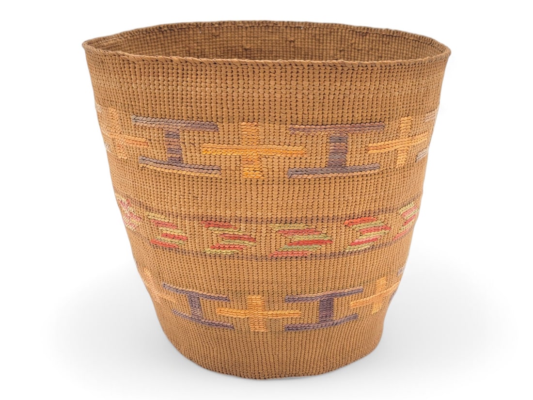 Tlingit Spruce Root Berry Basket w/ Polychrome Accents: A gorgeous Tlingit spruce root berry basket with polychrome geometric false embroidery accents in three rows around the side. Marked S12 on the underside with a small blemish as photographed. Measures