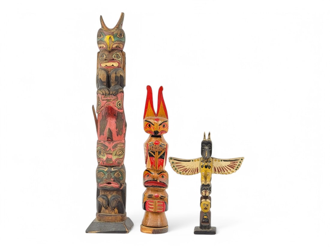 Hand Carved & Painted Wooden Totem Poles: A trio of early to mid 20th century tourist trade hand carved and polychrome painted wooden totem poles, one signed for R. Prichard of Schenectady, New York- possibly a former owner. Figures represent