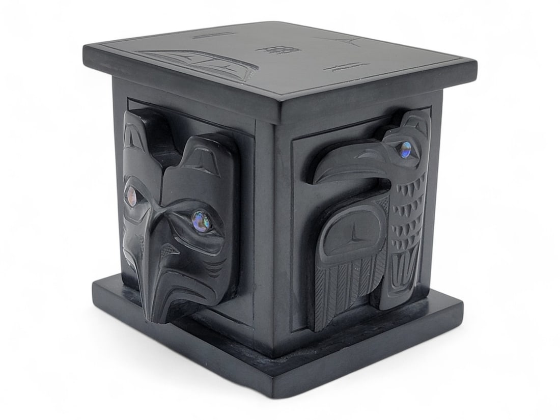 "Killer Whale & Salmon" Argillite Box w/ Formline Designs - Glen Pollard: A c.1993 lidded trinket box carved from black stone argillite by Haida Eagle Clan master carver Glen Pollard (b.1957). Pollard sources his argillite close to home, from the Slatechuck Mountain in Skid