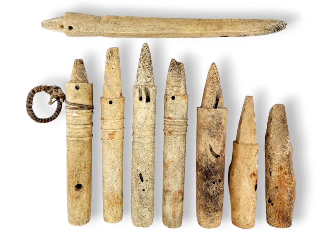 Aleut Bone Harpoon Transfer Socket Artifacts: Eight Aleut harpoon transfer sockets, carefully crafted from bone, some with drilled holes present, some with ridges, and one with retaining cord and ring as shown. The largest measures approximately