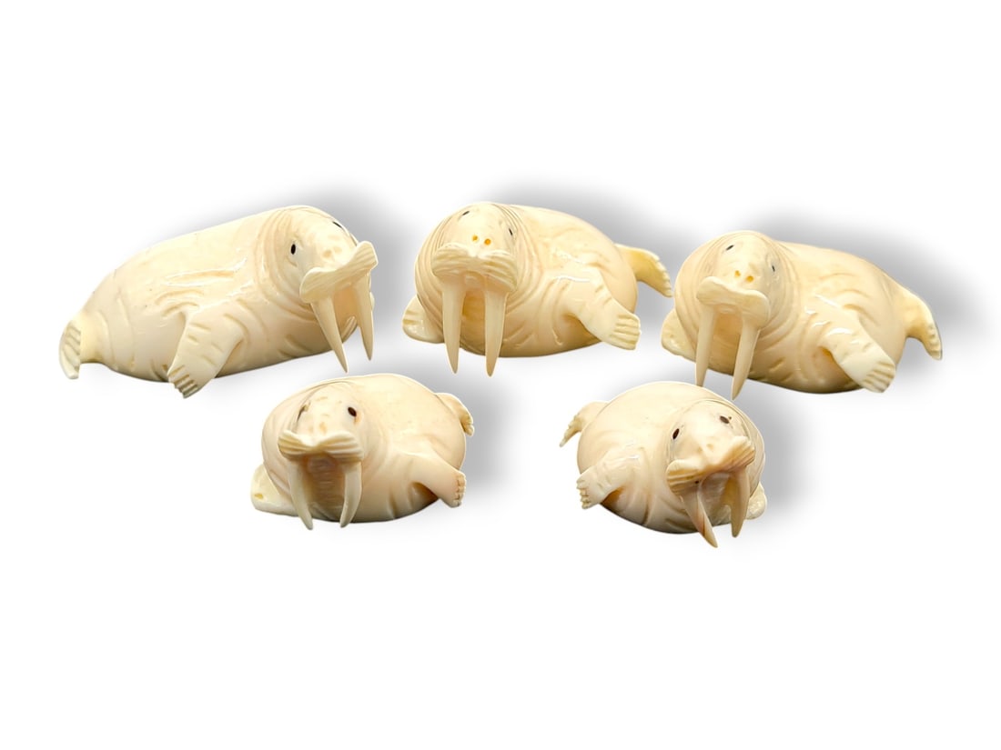 Walrus Tusk & Baleen Walrus Figurines - Bryant Koonooka: Five adorable carved and deeply incised walrus tusk figurines, each depicting a Pacific walrus resting upon its belly; eyes are inlaid baleen. Signed on the underside by Siberian Yup'ik carver Bryant 