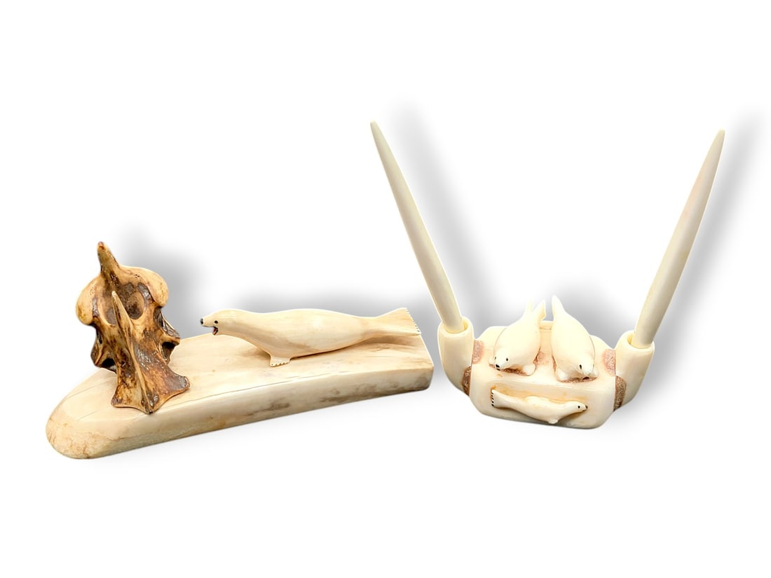 Seal Themed Walrus Tusk Pen Holders: A pair of carved walrus tusk pen holders, one sporting a large single carved seal and naturalistic pen holder made from mineralized vertebrae, the other a dual pen holder, with two walrus tusk pens pr