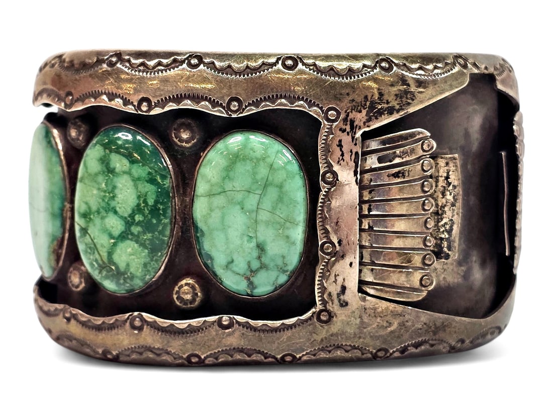 Navajo Sterling Silver & Turquoise Watch Cuff: A bold and finely hand-crafted Navajo sterling silver watch cuff with a wide band featuring a recessed rectangular timepiece setting flanked by applied fluted "raindrop" or fan-like silver elements on