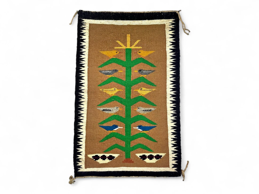Navajo Tree of Life Wool Rug 31.5" x 20": A handmade Navajo wool rug depicting the traditional Tree of Life motif, woven in dyed and natural fibers in a vibrant palette of green, yellow, blue, black, and tan. At the center, a corn stalk rises