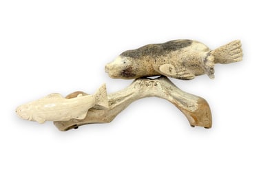 A Large Whalebone Sculpture of Seal Chasing Salmon