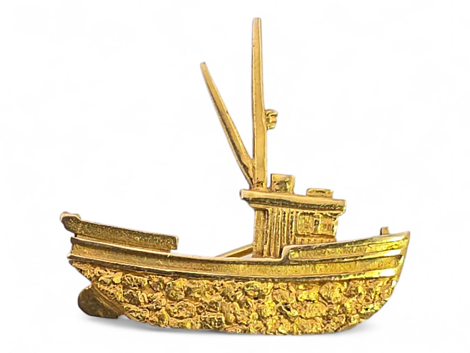 Alaskan Gold Nugget Purse Seiner Brooch: An Alaska-themed brooch in the shape of a commercial salmon fishing seiner, encrusted across the hull with Alaska gold nuggets over the 10 karat yellow gold pin; standard pinback en verso. Measures
