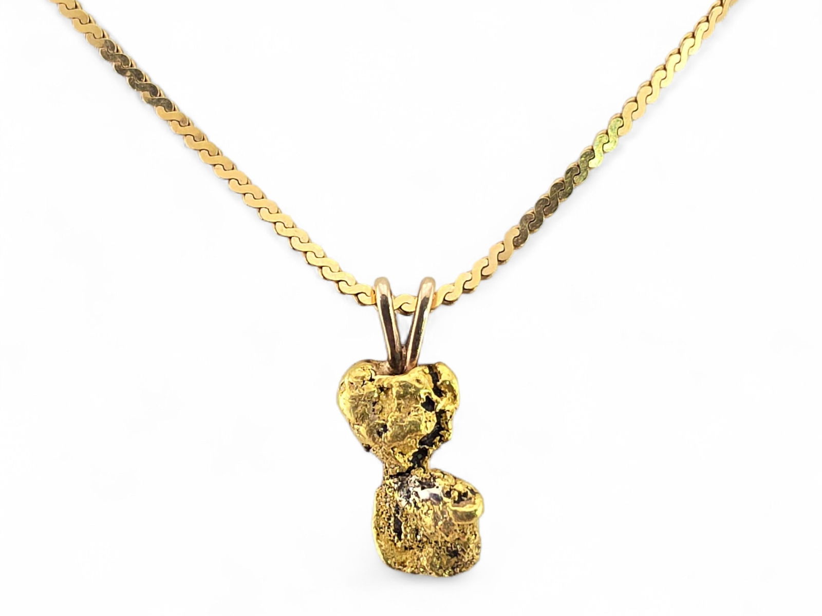 Alaska Gold Nugget Pendant on 14k Yellow Gold Serpentine Chain: An Alaska gold nugget pendant with 10 karat yellow gold bail, mounted upon a princess-length serpentine chain in 14 karat yellow gold, terminating in a spring-ring clasp. Pendant measures