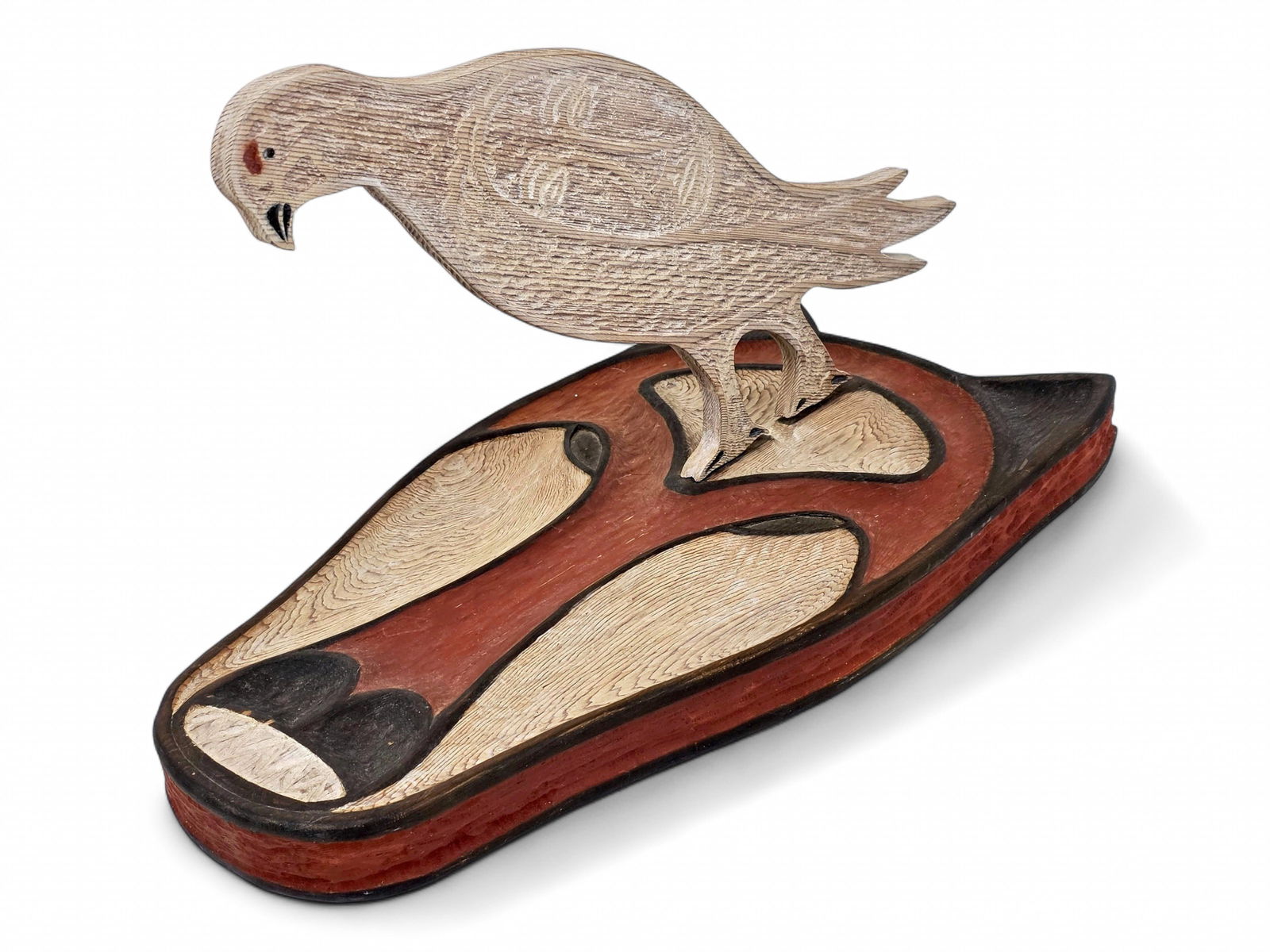 John Jay Hoover "Fox and Ptarmigan" Cedar Sculpture: A cedar wood sculpture by John Jay Hoover (1919-2011) depicting a polychrome carved and incised ptarmigan with embellished wings, each depicting a subtle spirit mask in human form. The bird is