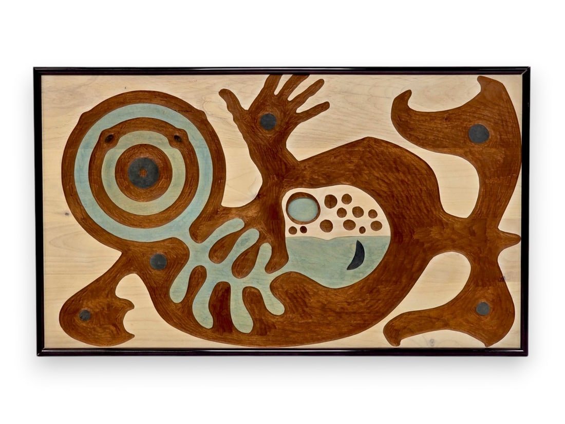 Ronald W. Senungetuk "Target Series S: Sealand Company" Alder Wood Carving: A museum-quality polychrome carving from alder wood, with applied stain accenting each element. The work, entitled "Target Series S: Sealand Company" depicts a sea otter transformation figure and was