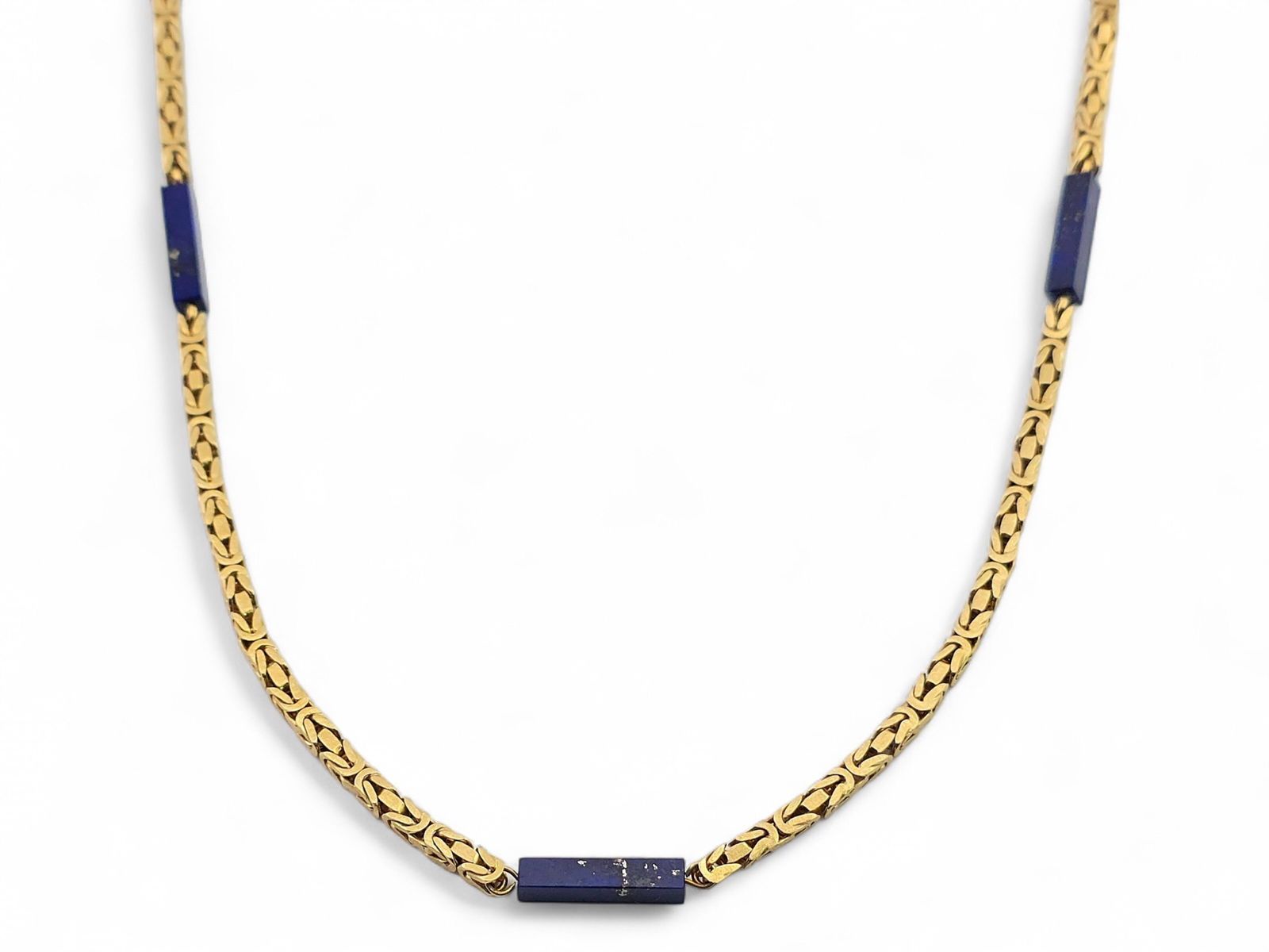 18k Yellow Gold & Lapis Byzantine Style Necklace: A sizeable opera-length necklace in 18 karat yellow gold, accented with seven rectangular lapis beads, spaced along the entire necklace length; chain is a modified Byzantine style with squared edges.