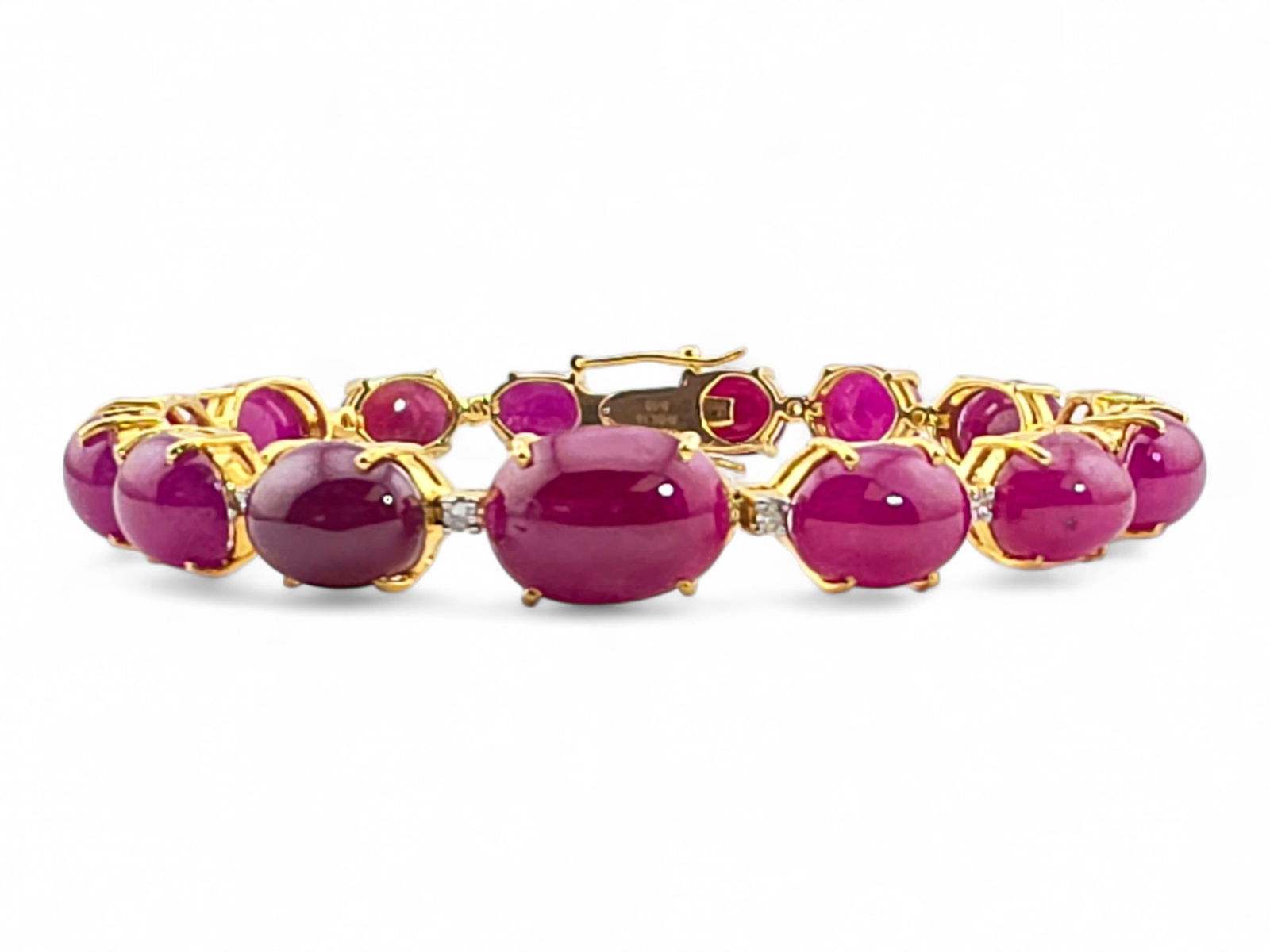 Ruby & Diamond Bracelet in 18k Yellow Gold: An 18 karat yellow gold link bracelet featuring fifteen prong-set ruby stones, each set apart by fifteen 1.50mm round prong-set diamonds. Bracelet terminates in a traditional bracelet clasp and measur