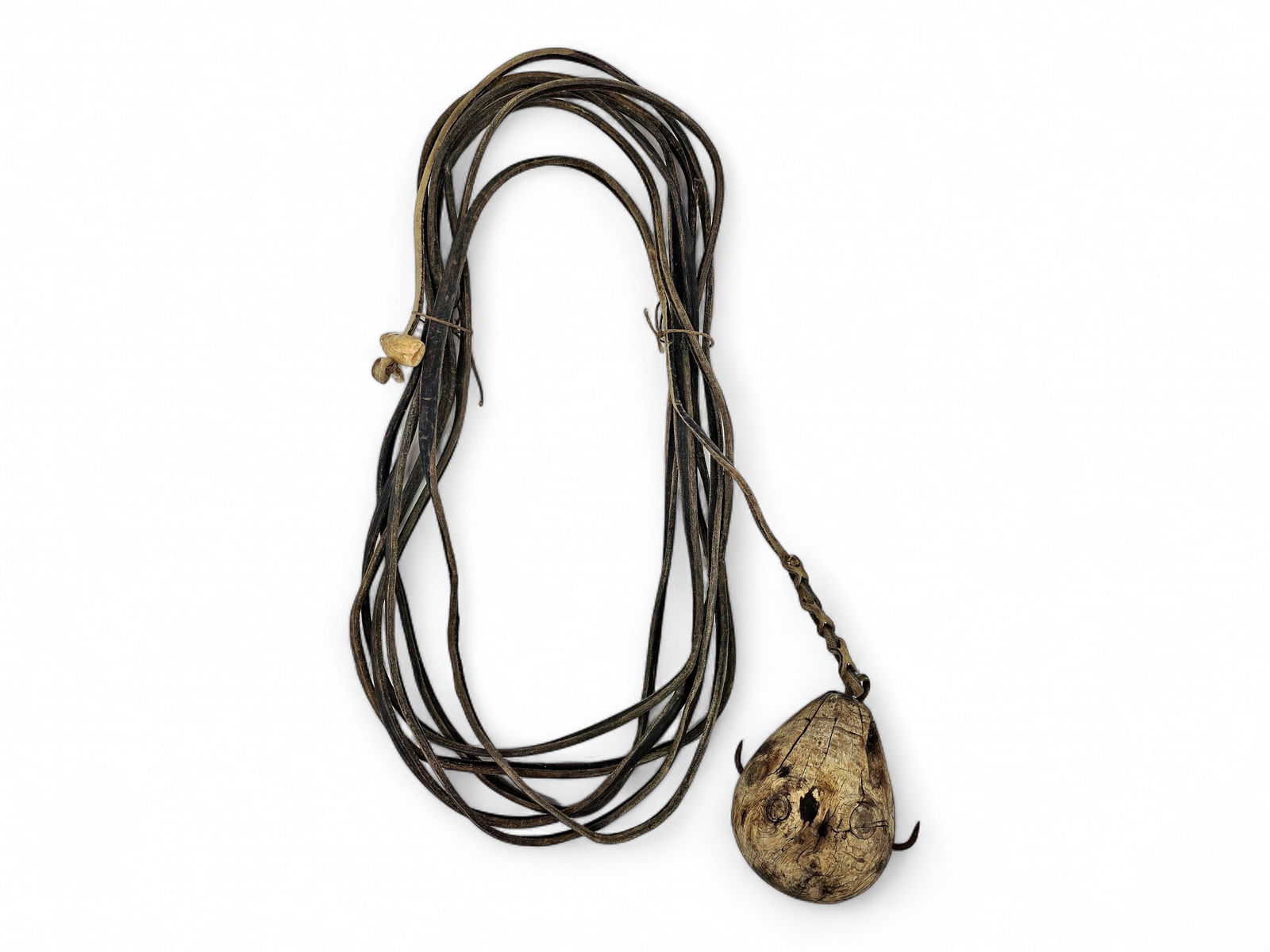 Inupiaq Seal Retriever w/Baleen Cordage: A 19th- or early 20th-century Inupiaq seal retriever used in traditional hunting to retrieve marine game taken in open waters, featuring an extremely dense, heavy, egg-shaped wooden center with four
