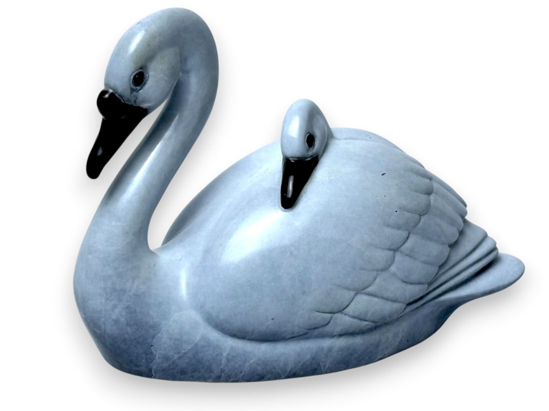 Regat Studios "Riding High" Bronze Swan & Chick: A bronze sculpture titled Riding High by Jacques & Mary Regat, depicting a swan carrying its chick in a graceful, naturalistic composition. Signed and numbered from a limited edition of 100, the work