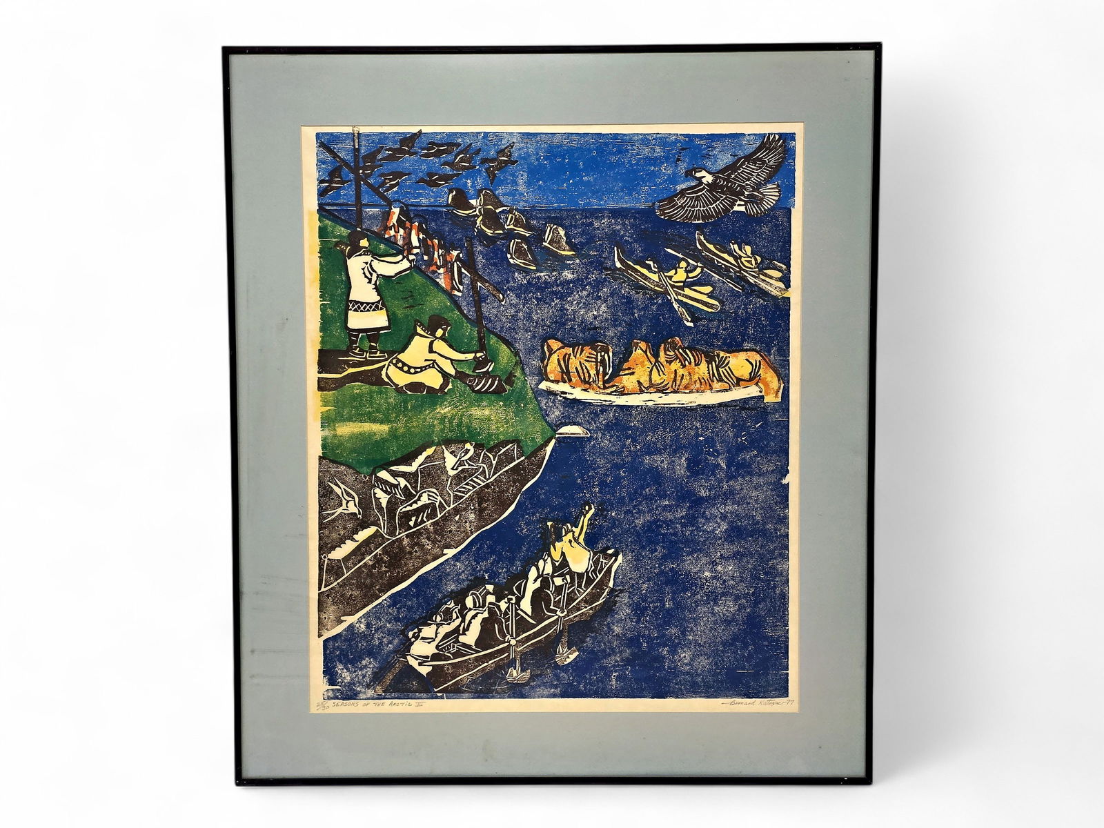Bernard Katexac "Seasons of the Arctic III" Woodblock Print: A signed and numbered 25/30 woodblock print titled "Seasons of the Arctic III" by Inupiaq artist Bernard Katexac (1922-1997) in simple colors, including shades of blue, pops of red, green, orange, and