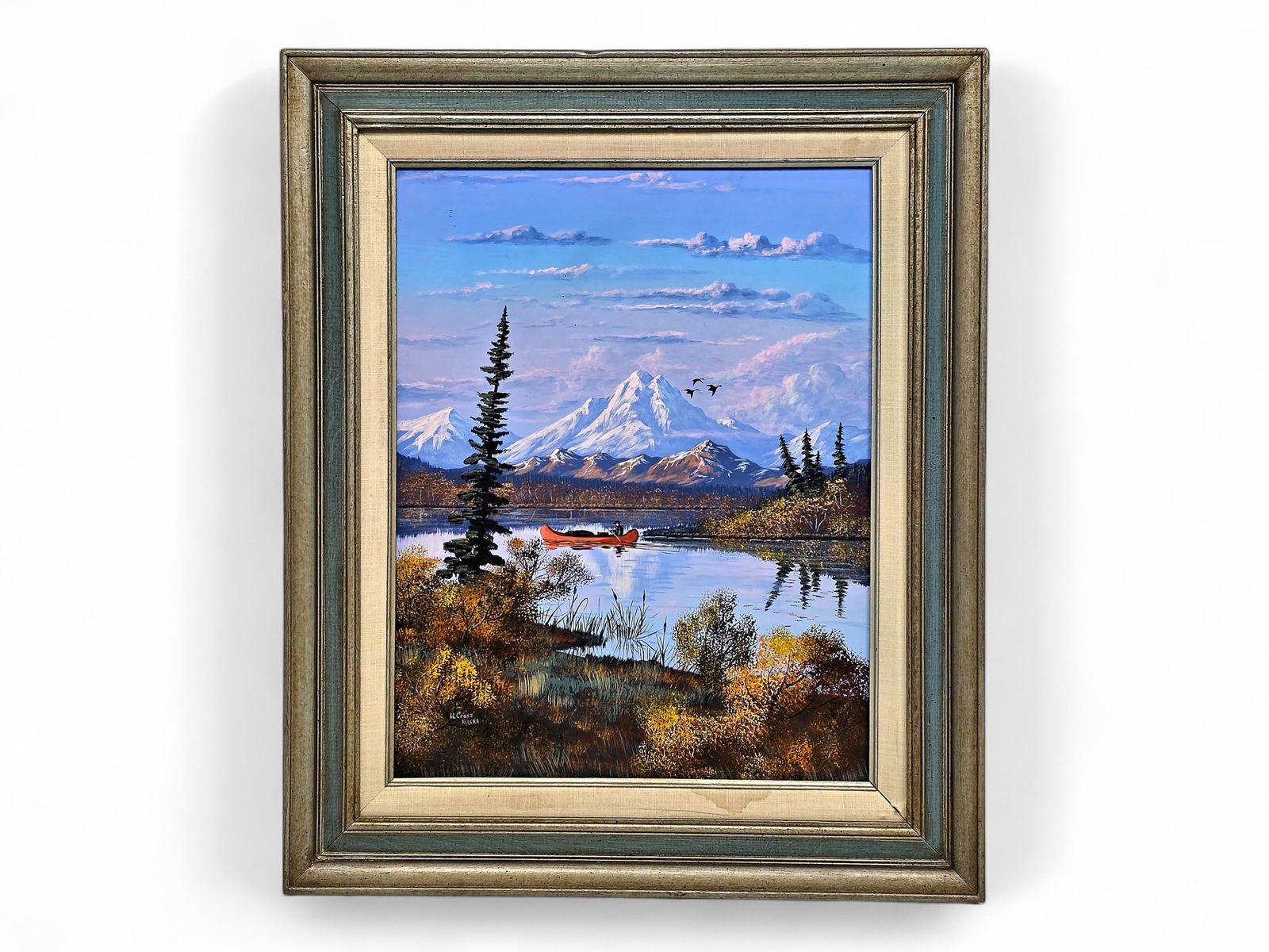 William Cross Painting of Denali Autumn Scene: An original painting depicting an Alaskan scene of a man canoeing on a lake in late autumn with waterfowl in flight overhead and backgrounded by the iconic snow-capped Denali (Mt. McKinley), signed