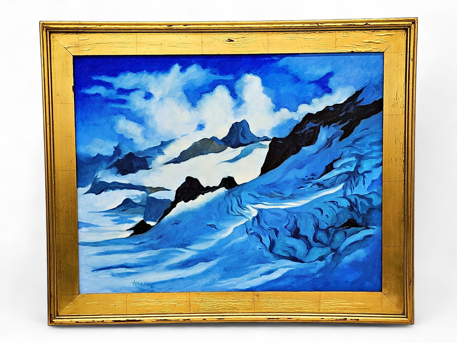 Betty Atkinson "A Break in the Clouds" Oil Painting: An original oil painting on canvas entitled "A Break in the Clouds" depicting low clouds surrounding the peak of a winter mountain, signed by Alaska artist Betty Atkinson (1930-2023) in the lower