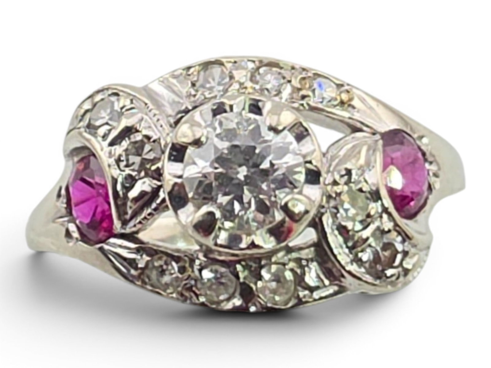 Art Deco 14k White Gold Diamond & Ruby Ring: An elegant Art Deco diamond and ruby ring crafted in 14-karat white gold, exemplifying the refined geometry and openwork styling that defined the period. The composition centers on a brilliant round d