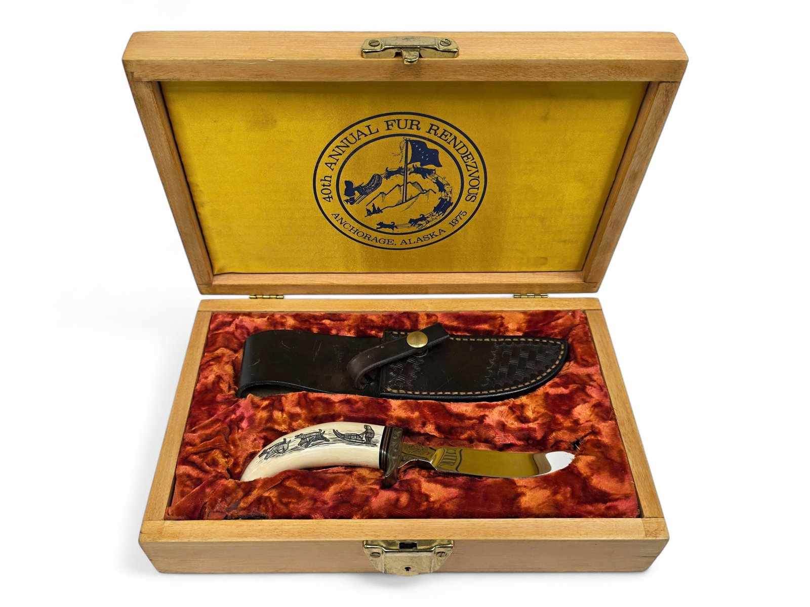Peter Mayac Scrimshaw Whale Tooth Gil Hibben Fur Rendezvous Knife c.1975: A fine and unused example of the circa 1975 40th Annual Fur Rendezvous commemorative knife set, representing a remarkable collaboration among some of Alaska's most accomplished artisans. Limited to
