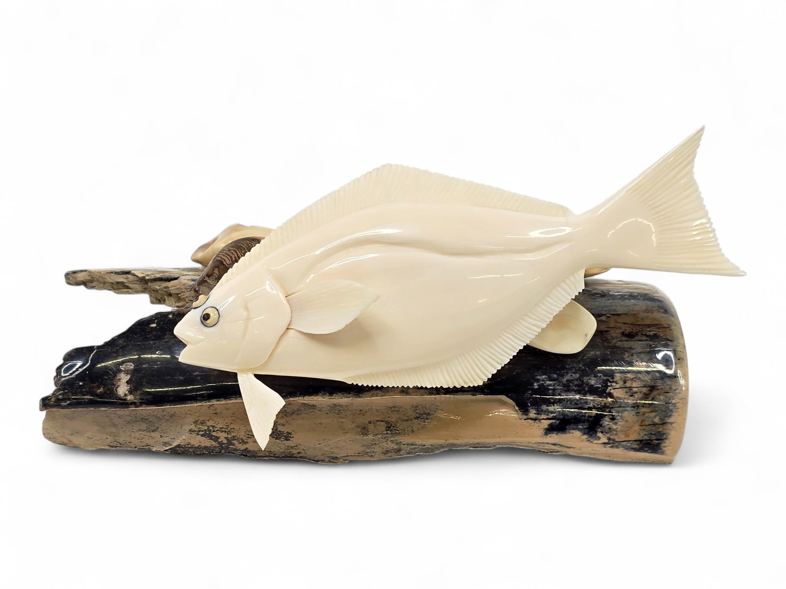 Walrus Tusk Halibut Sculpture on Mammoth Tusk Base - Brian Kulik: A finely carved marine sculpture by contemporary Inupiaq artist Brian Kulik (b. 1976), depicting a halibut gliding above an underwater landscape inspired by the rich fishing grounds of Alaska's