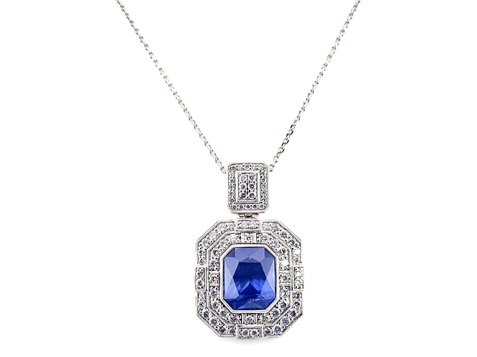 Oscar Friedman Platinum, 9.28 ct. Sapphire & 1.64 CTW Diamond Pendant Necklace: An exceptional Oscar Friedman Art Deco-inspired pendant necklace masterfully crafted in high-polish .950 platinum, centering on a magnificent natural blue sapphire corundum weighing an impressive