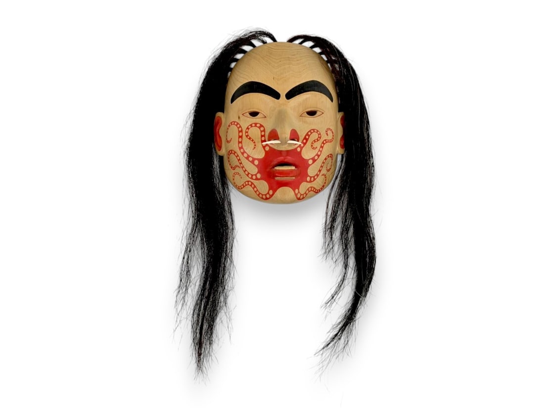 Northwest Coast Octopus Portrait Mask – Glen Rabena: A Pacific Northwest Coast mask by carver Glen Rabena (b. 1953), signed en verso and distinguished by an imaginative composition centered on a ring of vivid red octopus tentacles radiating from the mou