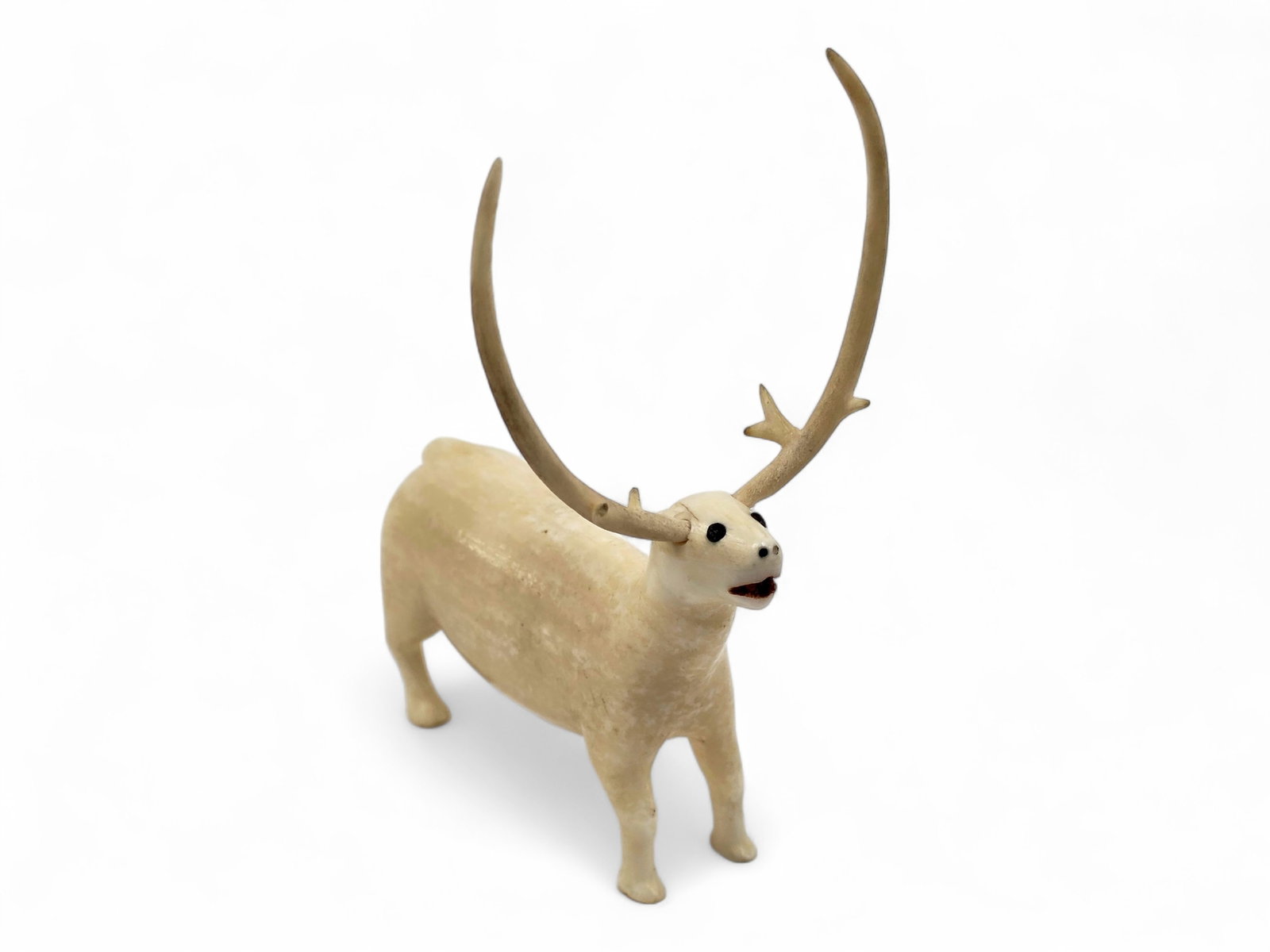 Folksy King Island Walrus Tusk Carving of Caribou: A charming and whimsical first-half-of-the-20th-century Alaska Native walrus tusk carving depicting a caribou, likely originating from King Island. Rendered in a delightfully folksy style, the figure 