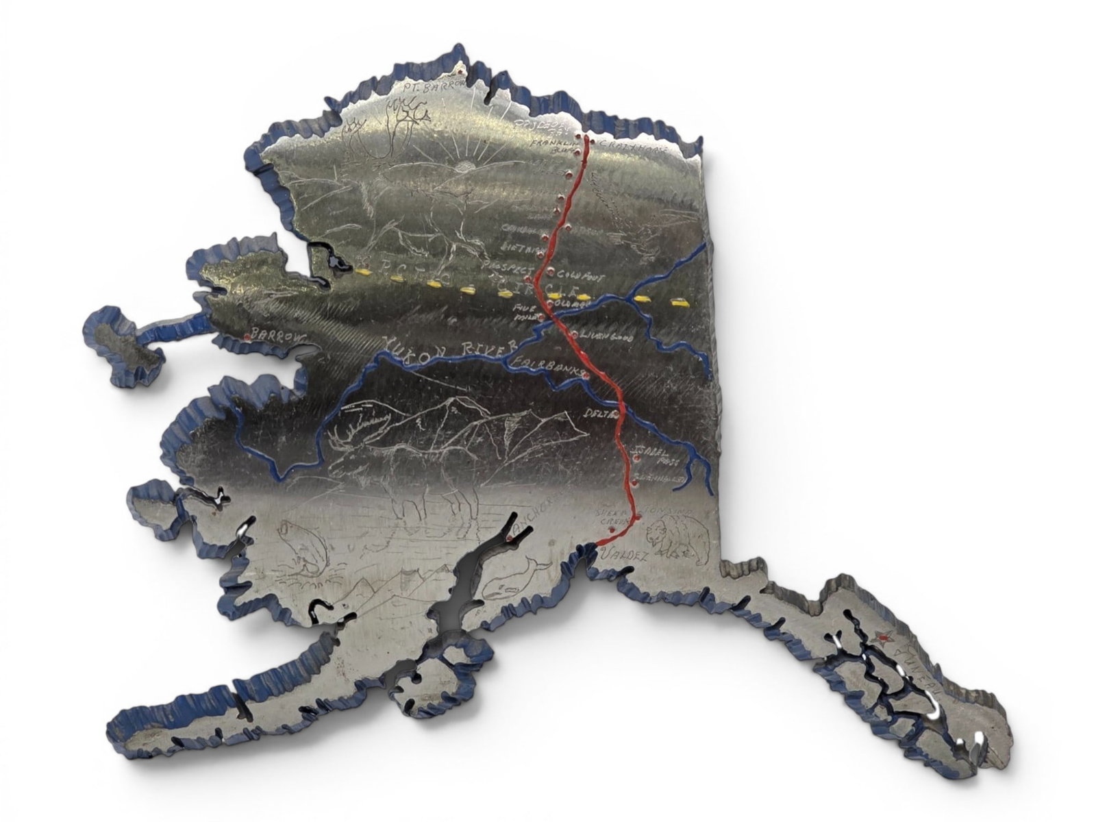 Trans-Alaska Steel Pipeline Sculpture of Alaska: A handcrafted wall sculpture in the shape of the state of Alaska, cut from the steel of the Trans-Alaska Pipeline and richly engraved with an intricate map celebrating the state's geography, wildlife,