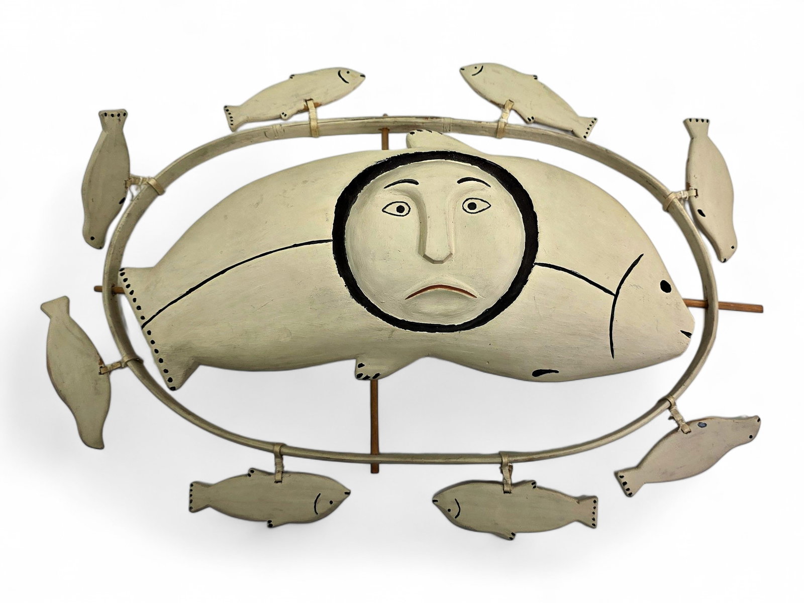 Scammon Bay Yup'ik Salmon Spirit Wheel – Mike Joe: A wooden spirit wheel hand carved and painted in a restrained polychrome palette by artist Mike Joe of Scammon Bay, Alaska, signed and dated June 1991 en verso. The composition centers on a stylized f