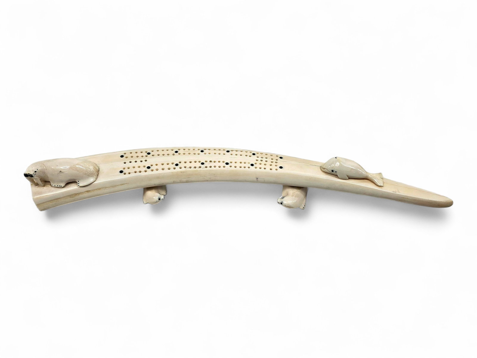 Walrus Tusk Cribbage Board w/ Walrus, Whale & Seal Carvings- Willy Topkok: A distinctive cribbage board by Iñupiaq artist Willy Topkok (20th/21st century) of Teller, Alaska, masterfully hand-carved from a naturally curved walrus tusk. Signed by the artist, the board