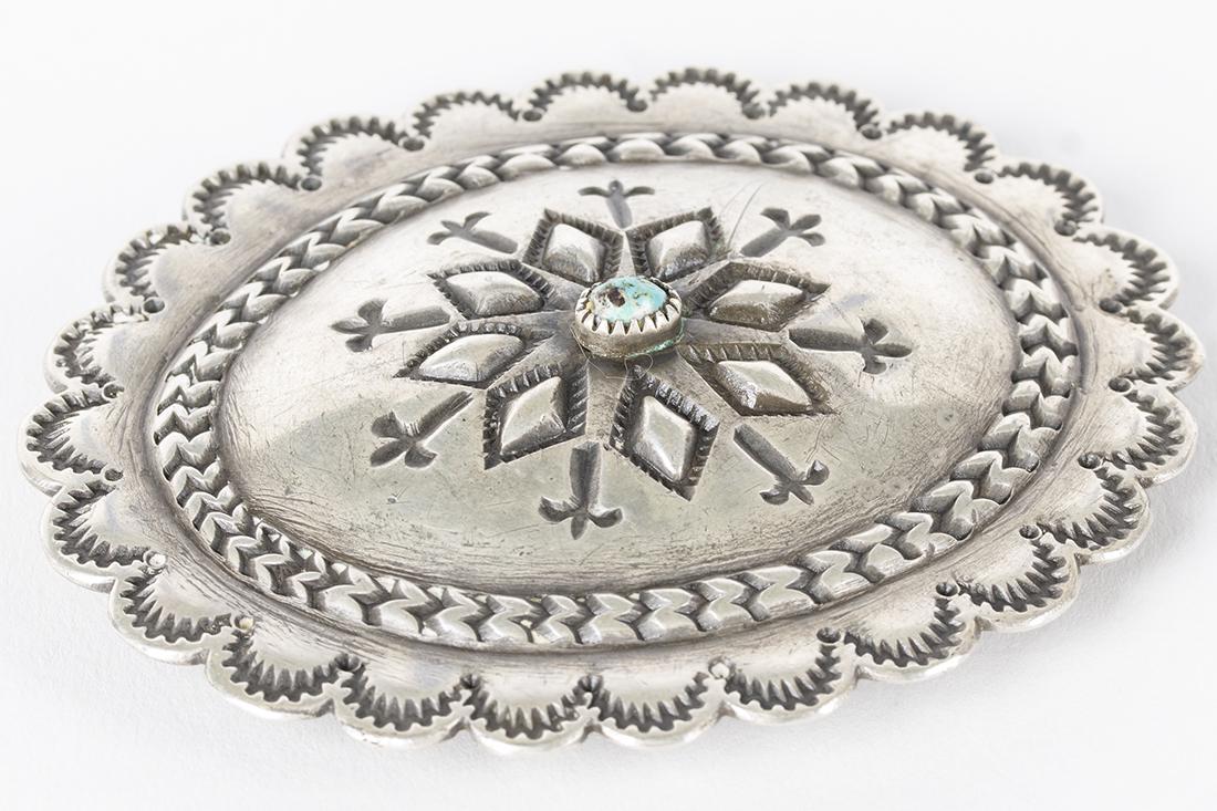 Southwestern Style Sterling Silver & Turquoise: Oval shaped silver and turquoise beltbuckle of Southwestern design.Etched designs surround the center placed turquoise. 3.75" x 3"