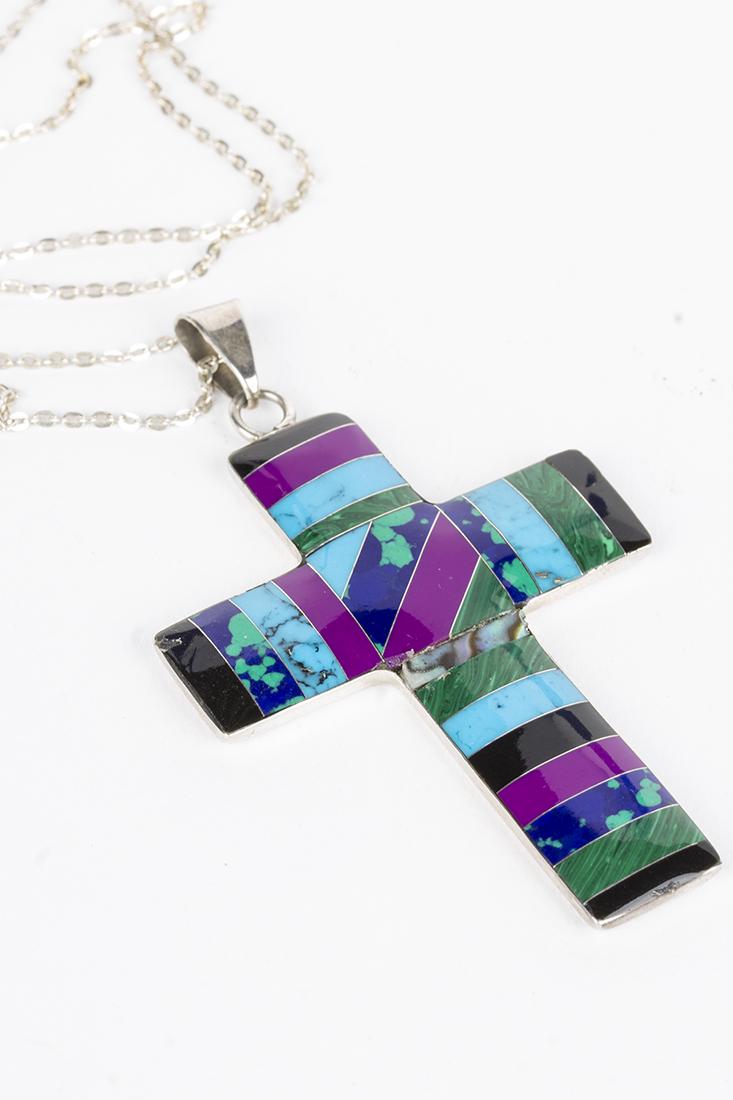 Multi-stoned and sterling silver cross on sterling: Sterling cross with gemstone inlays, including lapis, malachite, onyx, and turquoise. 20" sterling chain.