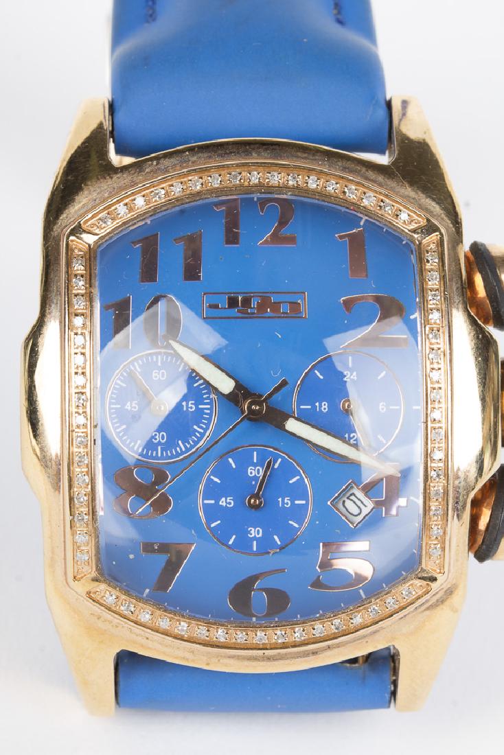 JOJO Diamond Chronograph Wristwatch: Incredible JOJO Chronograph wristwatch. Diamond studded bezel contains 98 diamonds in a gold toned setting, accenting and complimenting the blue face of the watch. Arabic numerals are golden while the