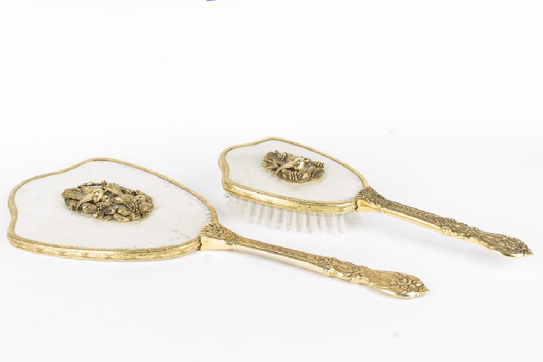 Vintage Gold Plated Brush and Hand Mirror: Vintage gold plated brush and mirror. Mirror is 13.5" long with a 6.5" reflective surface. Brush is 10" long. Brush head is 4" x 3". Handles are highly decorated and small sparrows appear on the rev