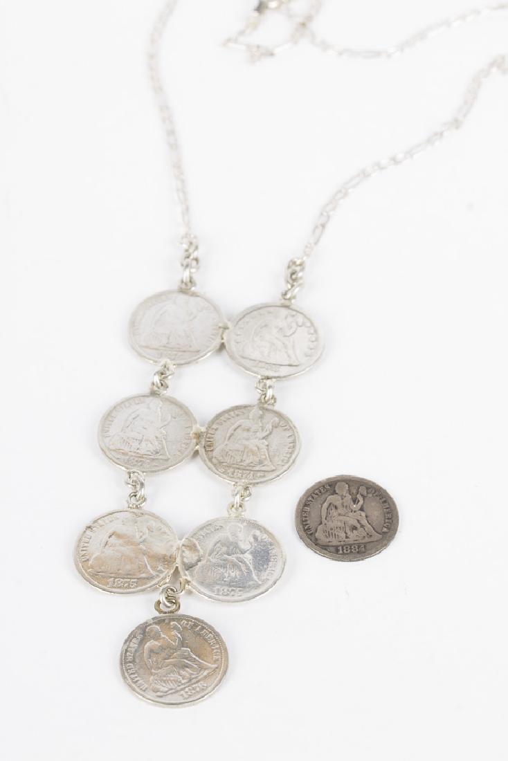 Silver Love Token Necklace: Vintage love token necklace. Pendant is composed of 7 love token, made from US silver seated liberty dimes, ranging from the 1850's to the 1870's. Necklace is 19" long, pendant is 3.5" long x 1 3/8