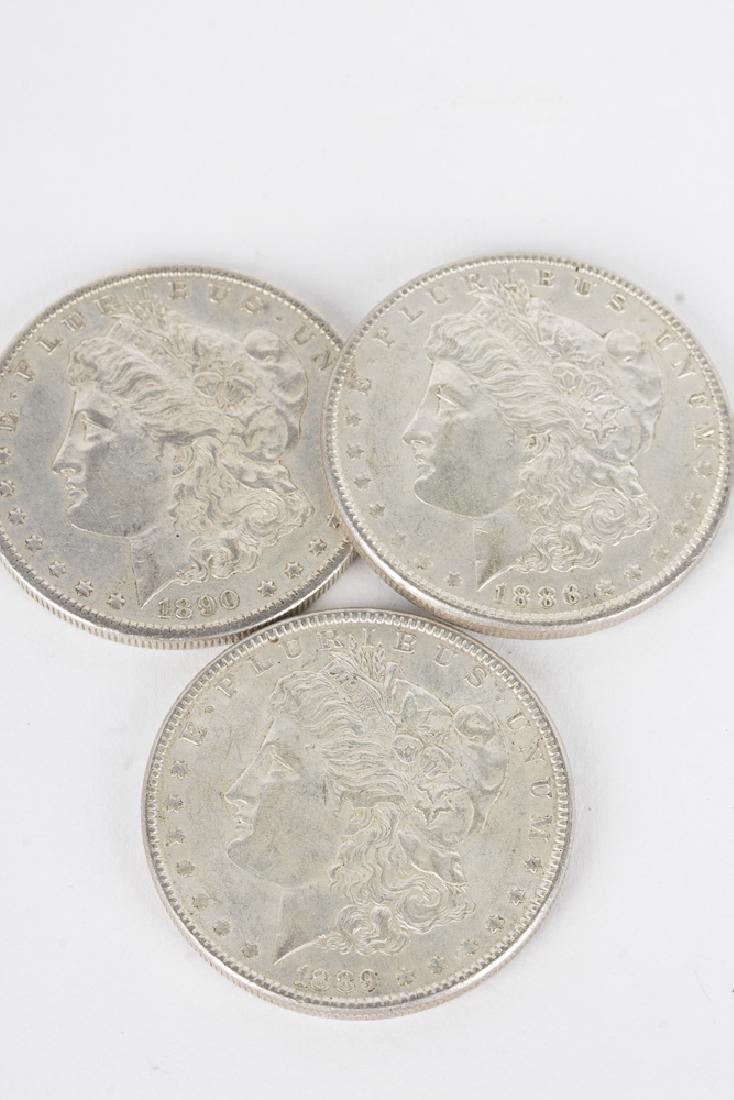 Lot of 3 90% Morgan Silver Dollars: An 1886, 1889, 1890S Morgan dollar in brilliant uncirculated condition. 90% fine silver, 0.7734 troy ounce pure silver per coin. 80.16g