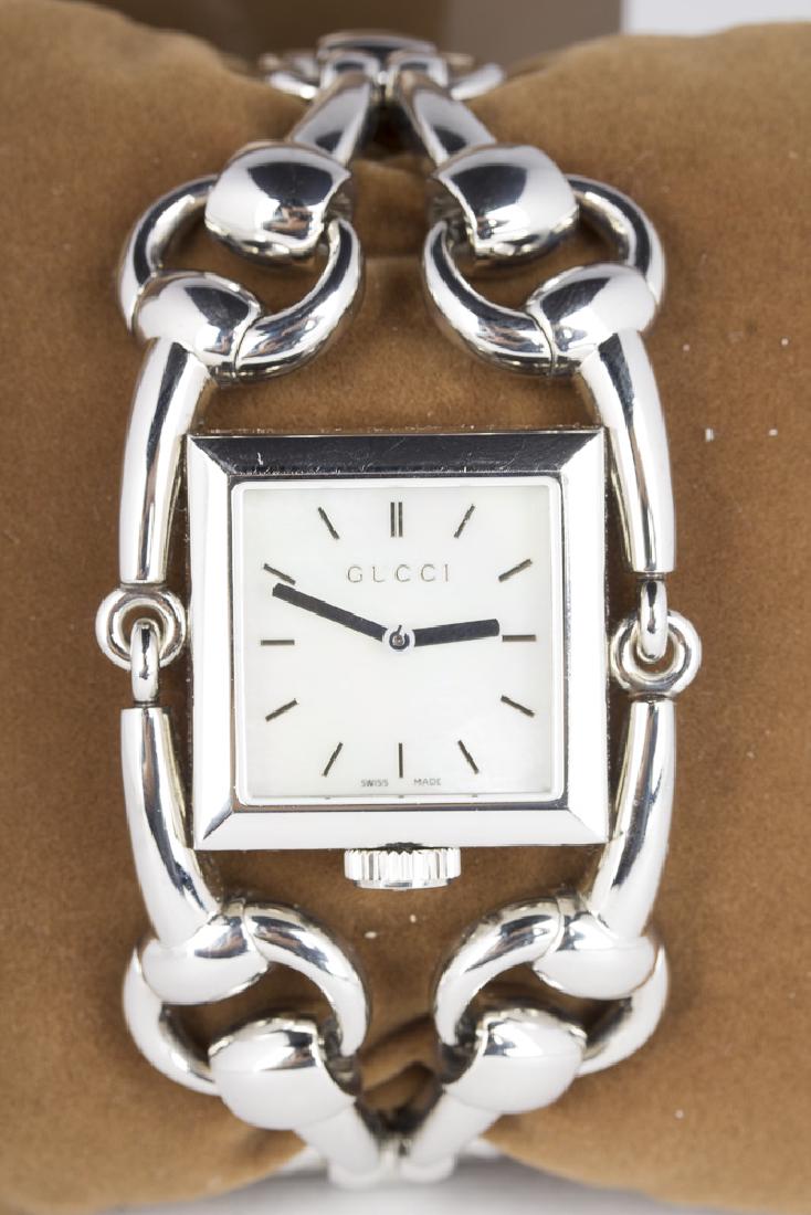 GUCCI Signoria Swiss Made Wristwatch: Gucci Signoria 116.3 Swiss made quartz wristwatch. Stainless case, bezel, and bracelet. Mother of Pearl face with silvertone minute marks and center mounted hands. 12311488. Crown at 6 oclock position