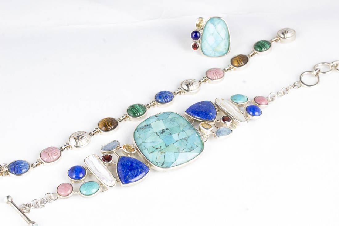Collection of WHITNEY KELLY Sterling and Gemstone: Three piece collection of Whitney Kelly jewelry. Approx 7.5" sterling scarab bracelet, with lapis, malachite, tiger's eye, and pink coral. Slide and lock clasp. 19.50gms. Size 8.25 sterling ring with