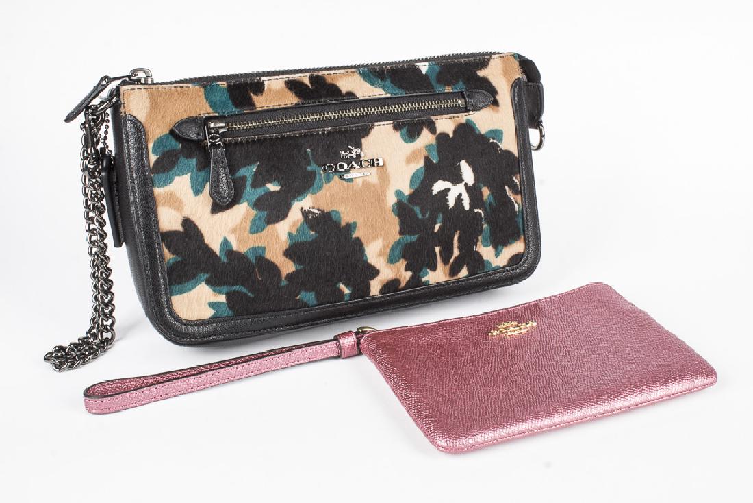 COACH Purse and Wristlet: A collection of 2 Coach accessories, the first is a 6 1/4" x 4 1/4" metallic pink wristlet, with a full length zipper and 6" strap. The second is a 9" x 6" x 2" wide purse with outside zipper pocket.